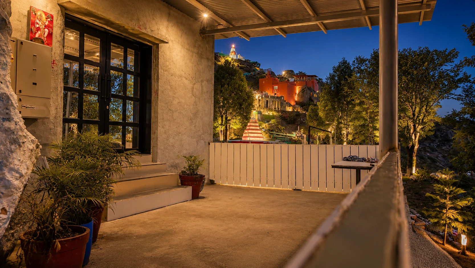Evening on the verandah at Guru Shikhar Heights, with the temple hill beyond
